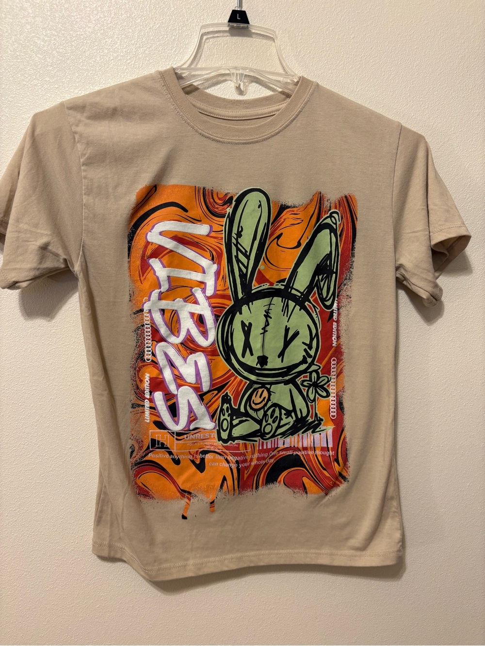 Hustle  Beige Tee with Green Bunny & Orange Graphic